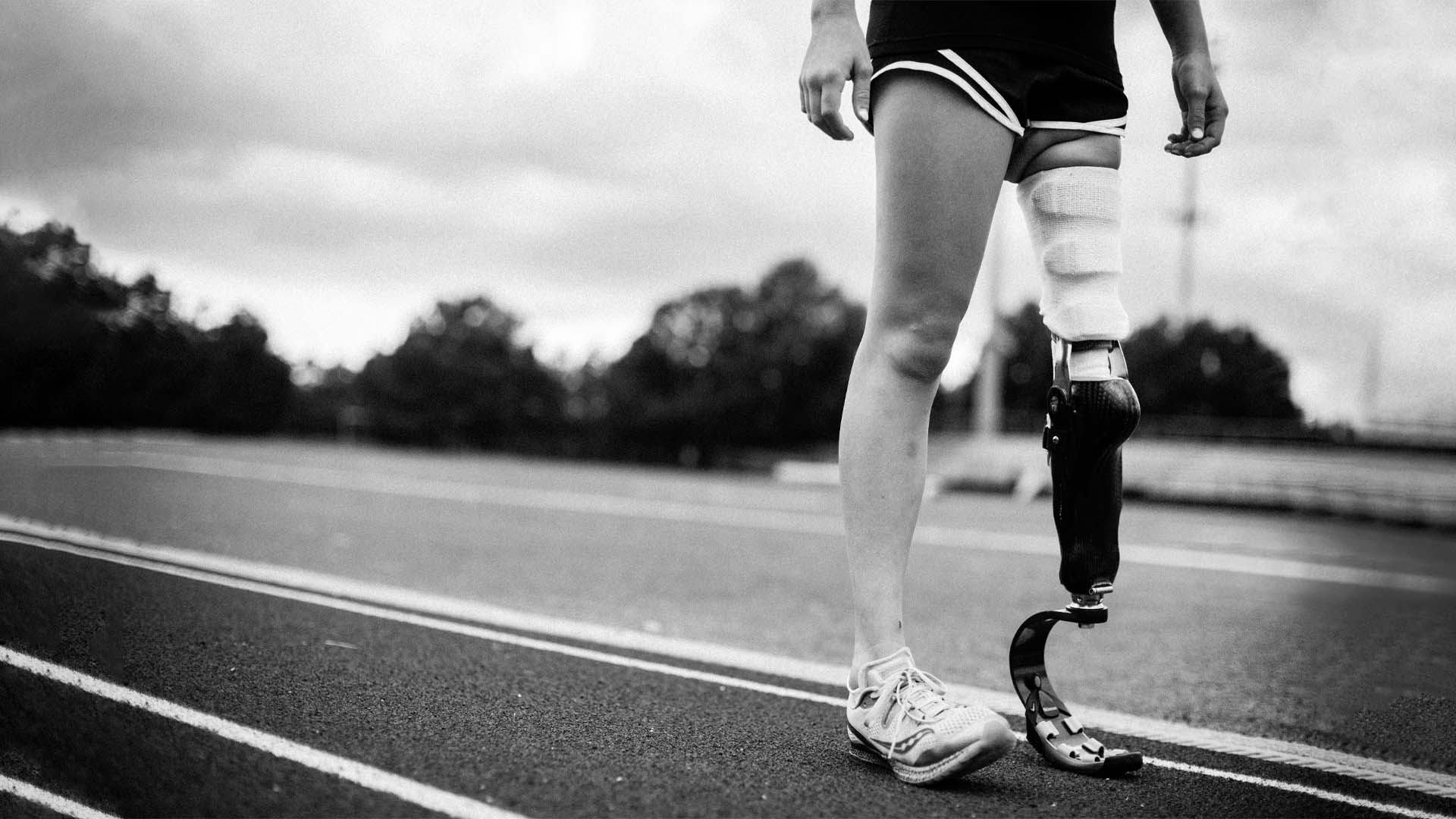 black and white photo of a runner with a prosthetic leg