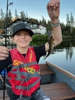 Osteosarcoma patient toby holds up a fish