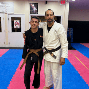 Gavin in a karate uniform with a brown belt