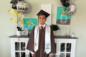 Dylan in a graduation cap and gown