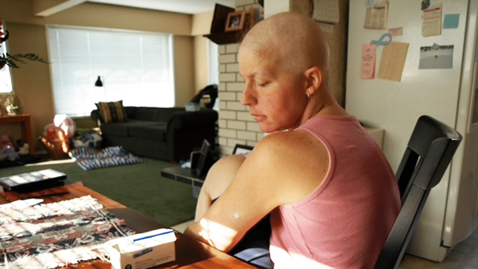 Woman looking down at the medication she needs to take