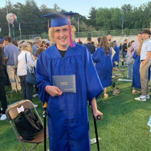 Tyler Stowe Robinson in a blue graduation cap and robe